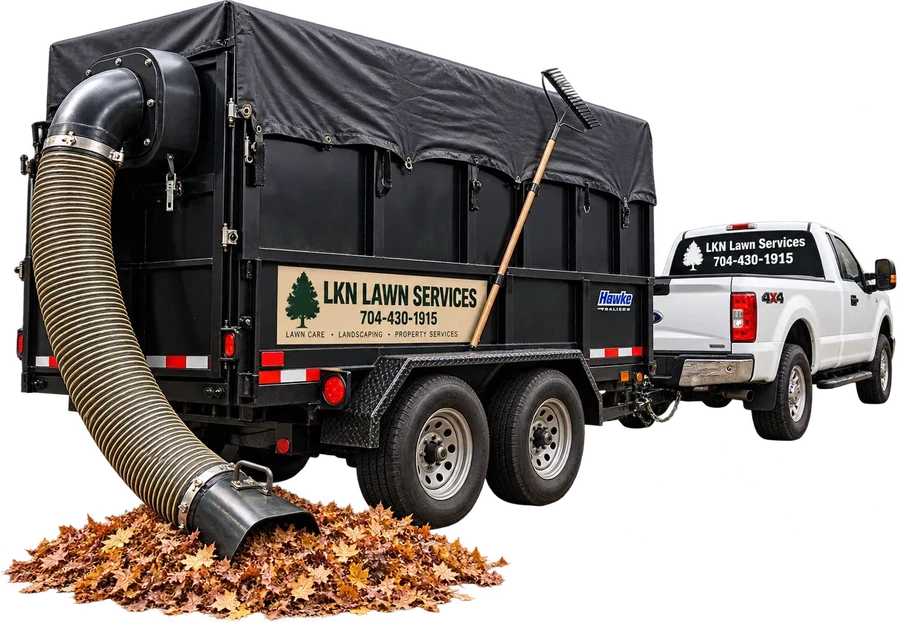 Branded leaf vacuum trailer and pickup with the hose in a pile of leaves